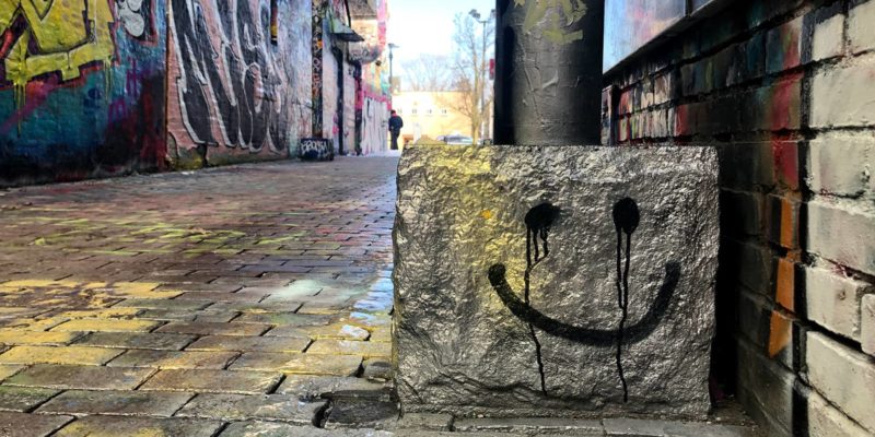 Photo of a smiley face spraypainted on a stone slab